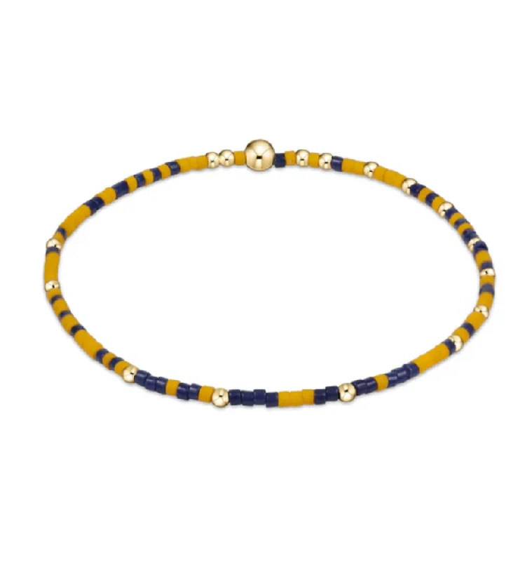 Bangle bracelets with colorful gemstone accents for a fun and vibrant pop of color-gameday hope unwritten bracelet - golden yellow and matte navy by enewton